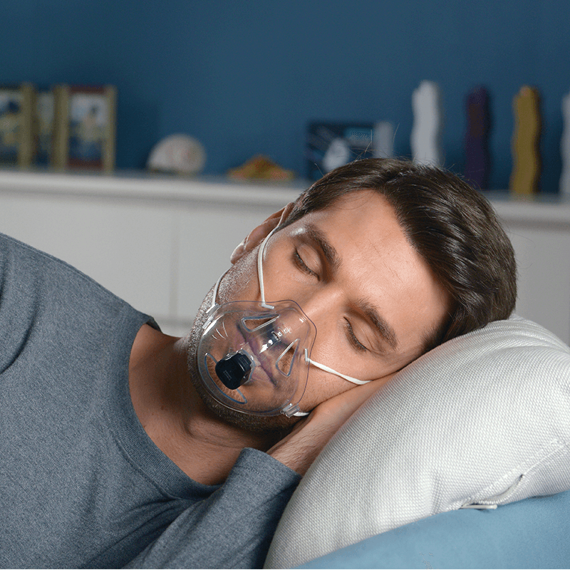 A man sleeping with a portable sleepbreathing monitor