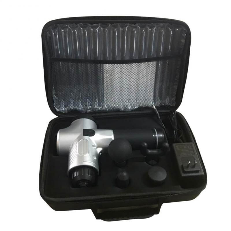 Light grey deep tissue massager, USB charger and spare parts packed in an open suitcase