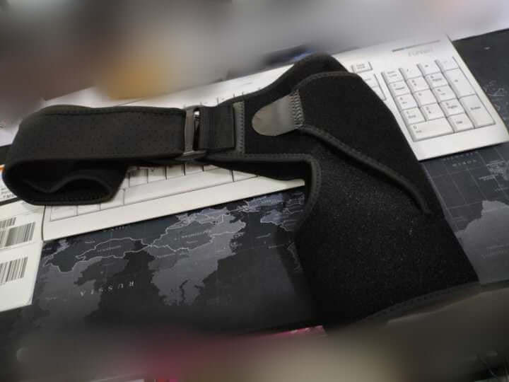 Unisex Orthopaedic Shoulder Support Brace on a keyboard