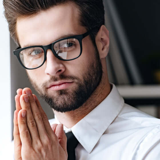 Young man wearing anti-blue light gaming glasses with black frame color