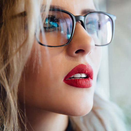 Young woman wearing anti-blue light gaming glasses with black frame color