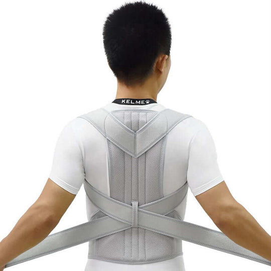 A rear view of a man wearing a grey posture corrector