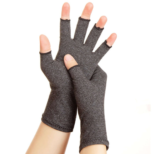 Woman hands wearing copper arthritis compression gloves